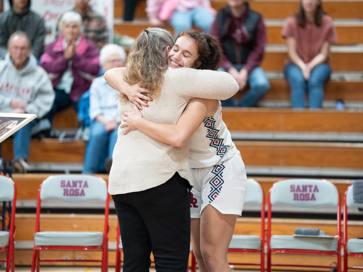 Sophomore night is in full swing as sophomore Ivy Gonzalez hugs head coach Lacey Campbell ahead of the game against American River at home on Friday, Feb. 21, 2025.