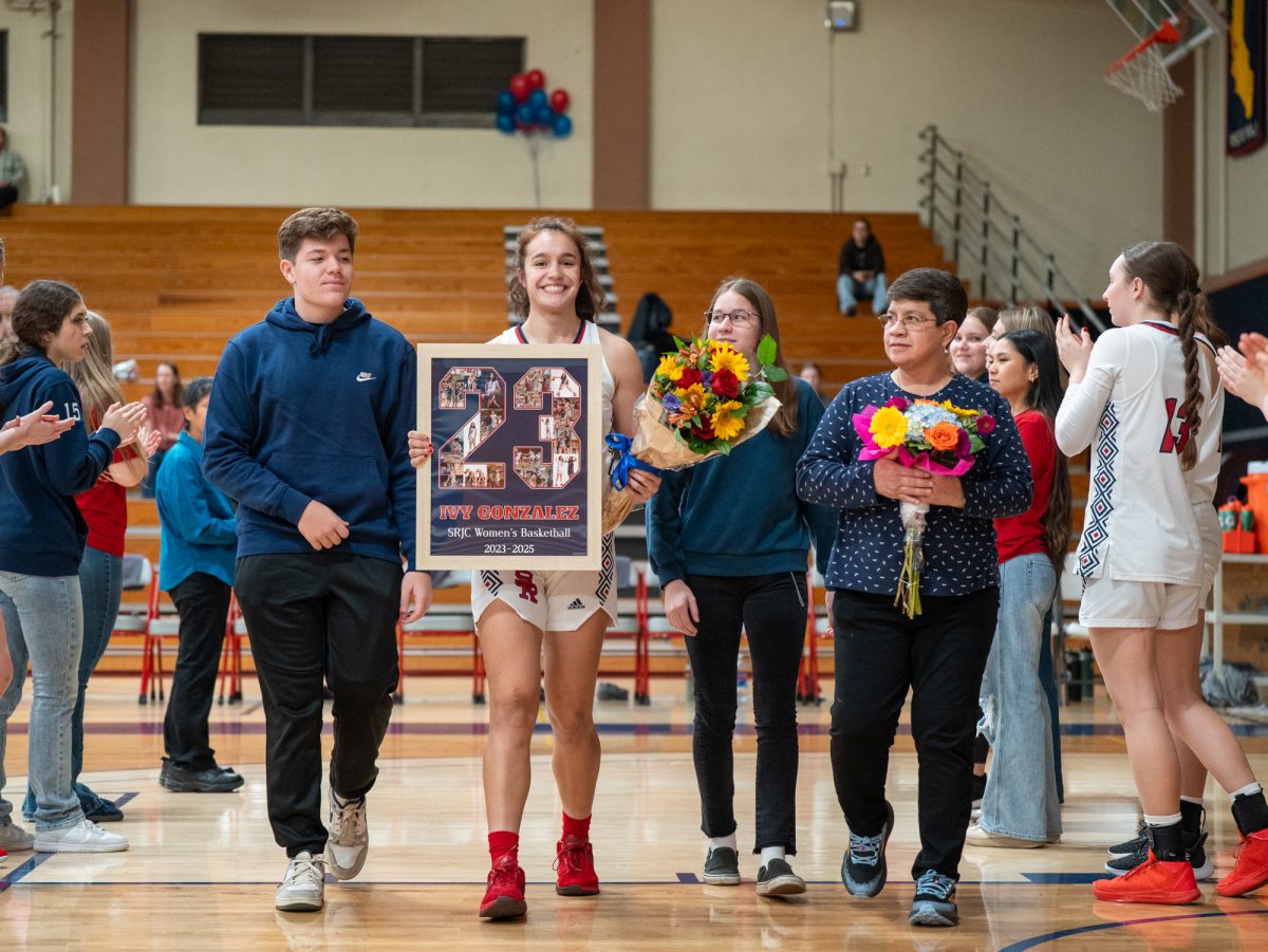 Sophomore Ivy Gonzalez walks with her cousin, sister and mom ahead of the game against American River at home on Friday, Feb. 21, 2025.