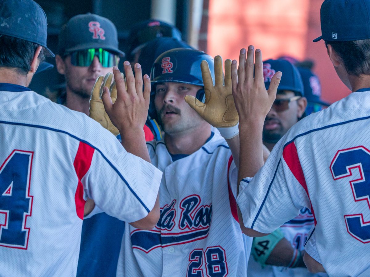 SRJC center fielder Shane Moran goes up for five after a single from third baseman Caze Derammelaere sends him home in the bottom of the fourth at home against Modesto on Tuesday, Feb. 25, 2025.