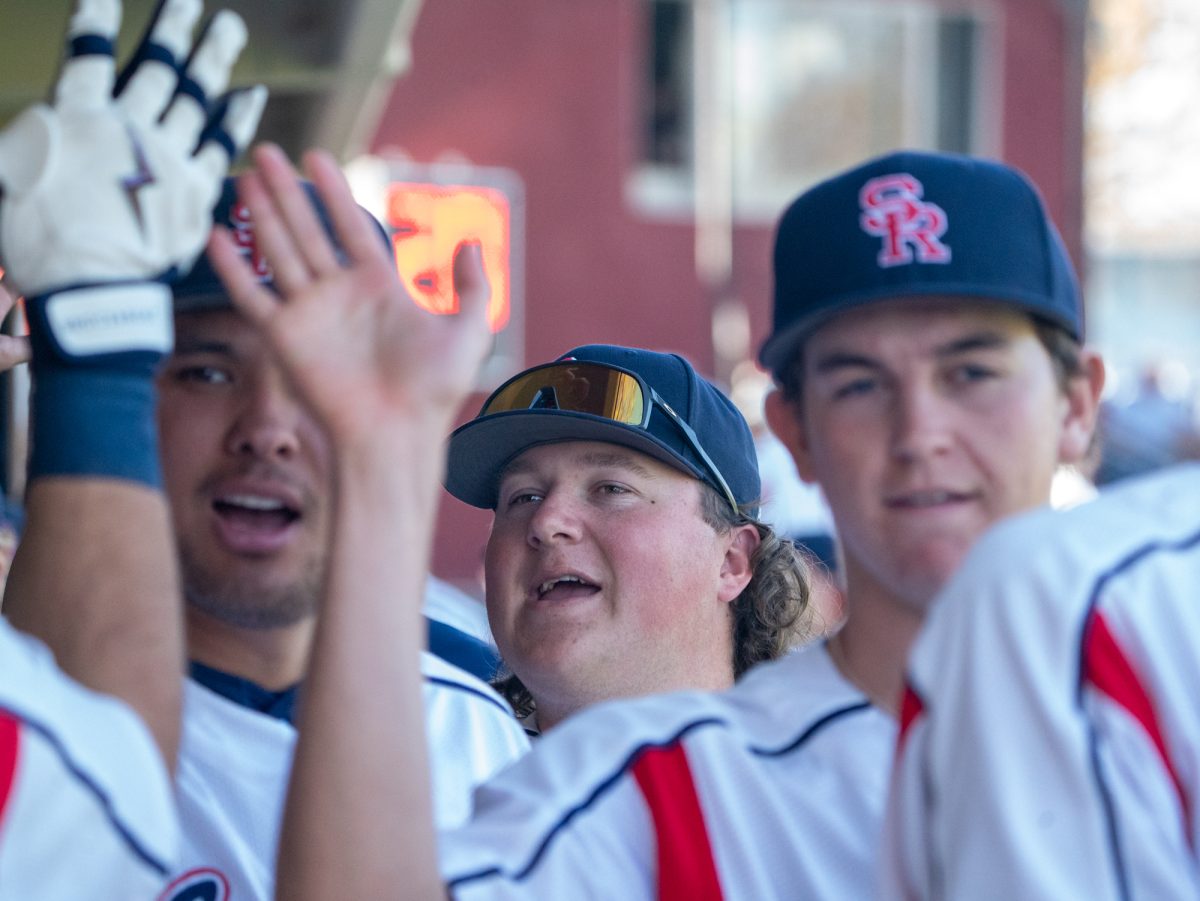 Pitcher Luke Dillon celebrates in the dugout with the team after another run is scored against Modesto at home on Tuesday, Feb. 25, 2025.