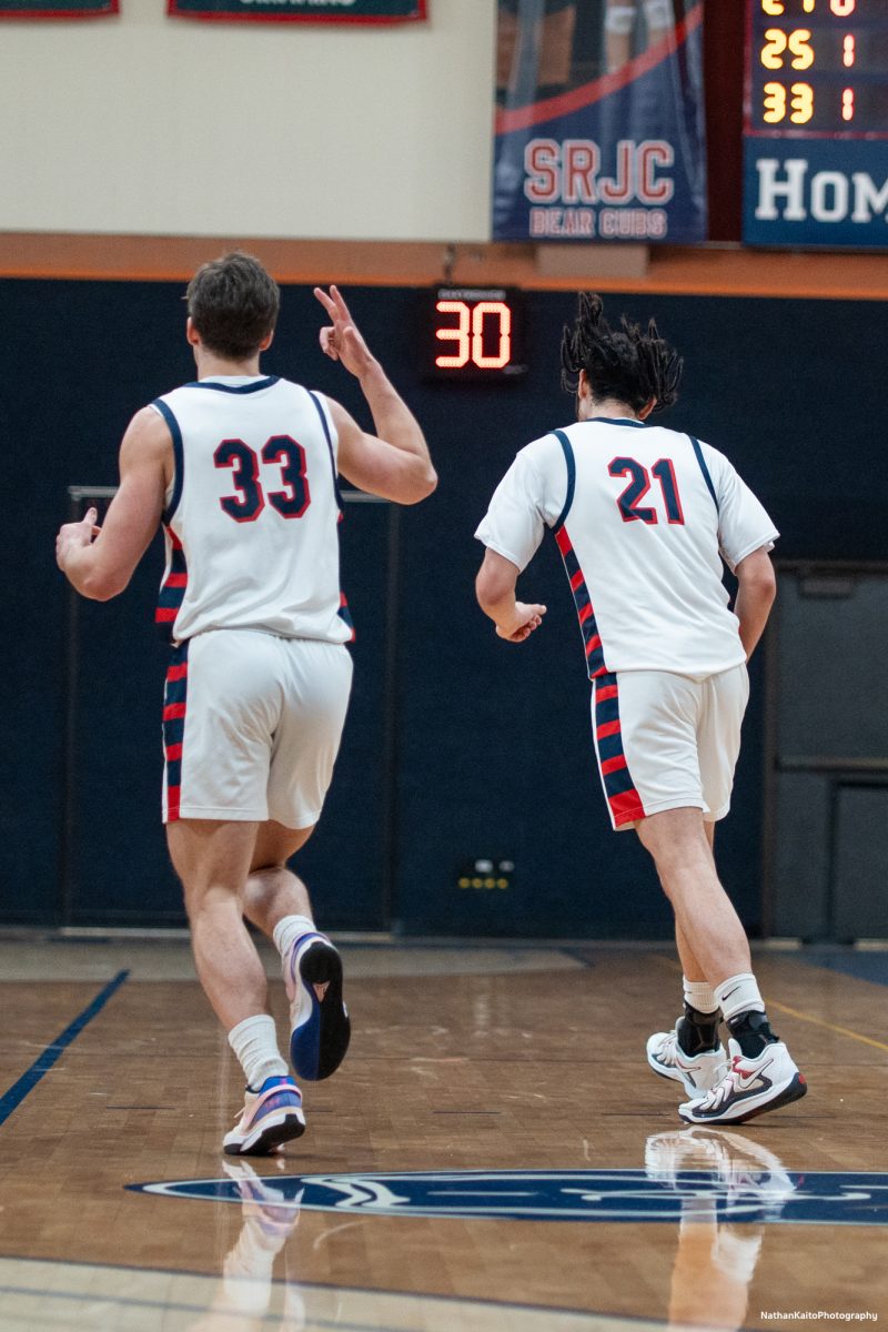 Bear Cubs' forward Audon Forgus points up three fingers to celebrate Tayden Collin's three pointer against American River at Haehl Pavilion on Friday, Feb. 21, 2025.