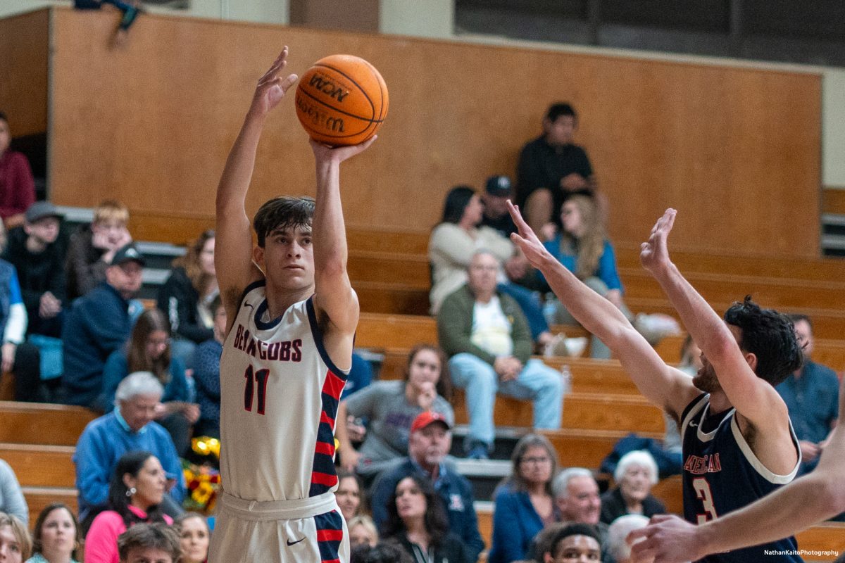 Bear Cubs' guard Spencer Langowski unleashes a shot as the Beavers' guard Micah Johnston raises a hand to block it at Haehl Pavilion on Friday, Feb. 21, 2025.