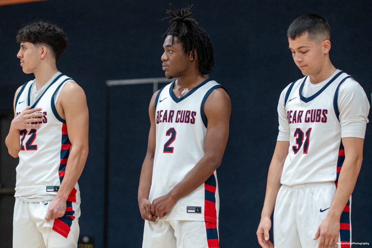 Bear Cubs' sophomores, Andrew Pengel, left, Yanik Anderson, center, and Kobe Gatti, right, stands somberly as the national anthem echoes around Haehl Pavilion on Friday, Feb. 21, 2025.