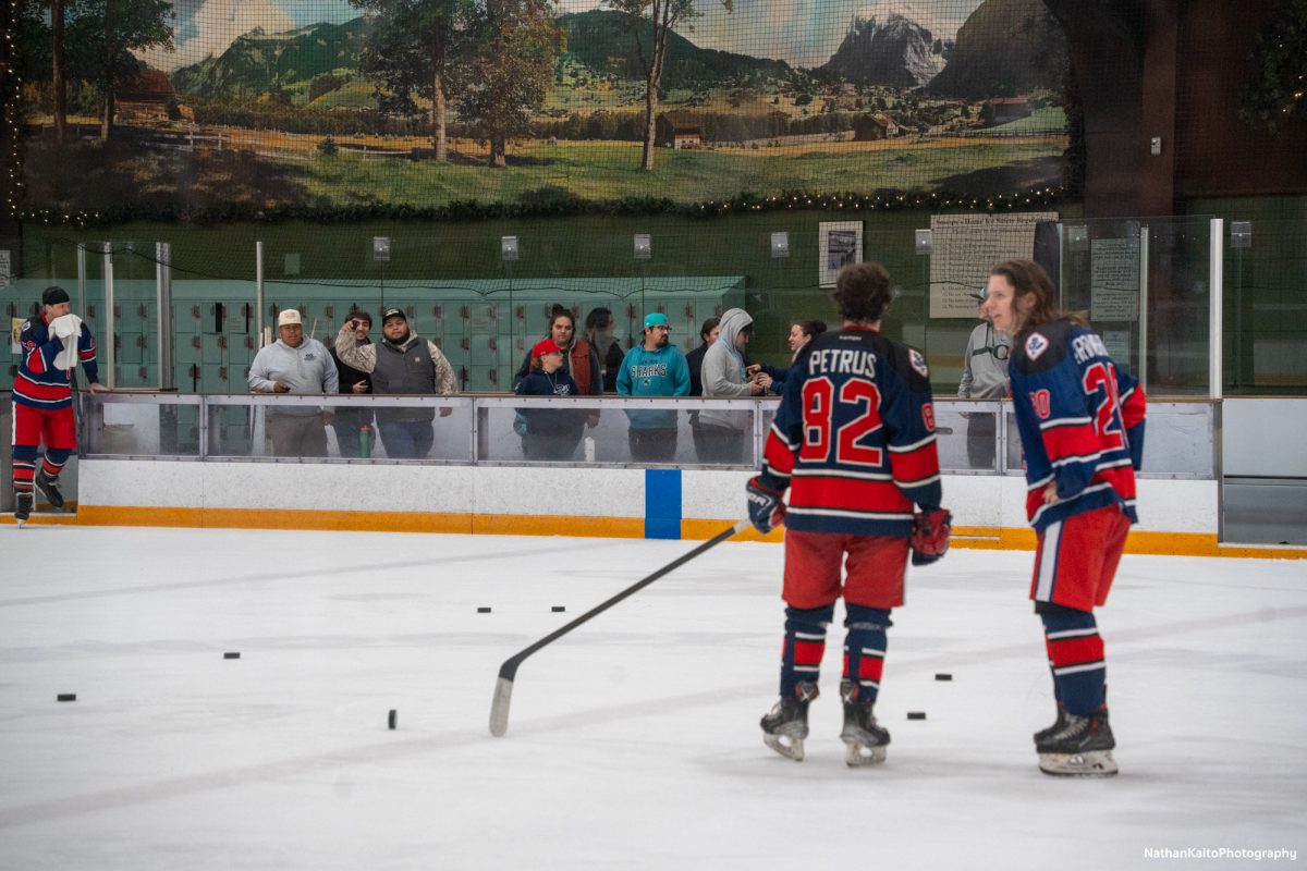 Attendees walk up to the ice to play "Chuck a Puck" for a chance to win some SRJC merchandise during the second intermission at Snoopy's Home Ice on Friday, Jan. 31, 2025.