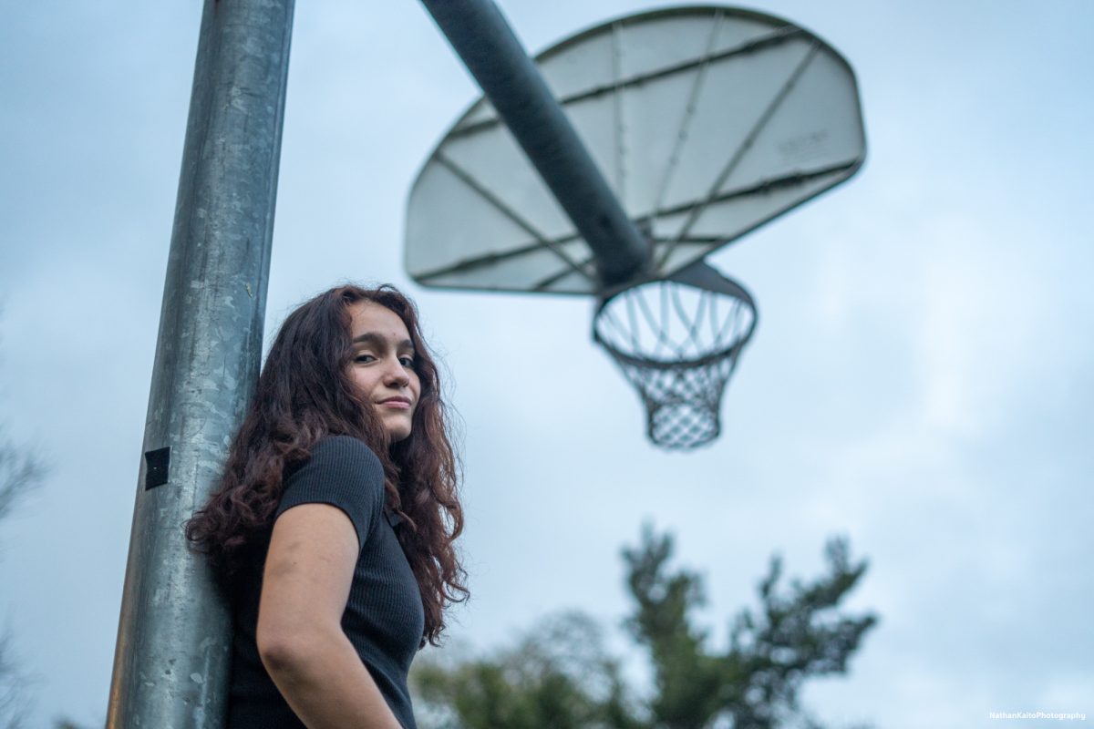 Bear Cubs' guard Ivy Gonzalez leans on a basketball hoop outside of outside of Polly O’Meara Doyle Hall on Monday, Feb. 24, 2025.