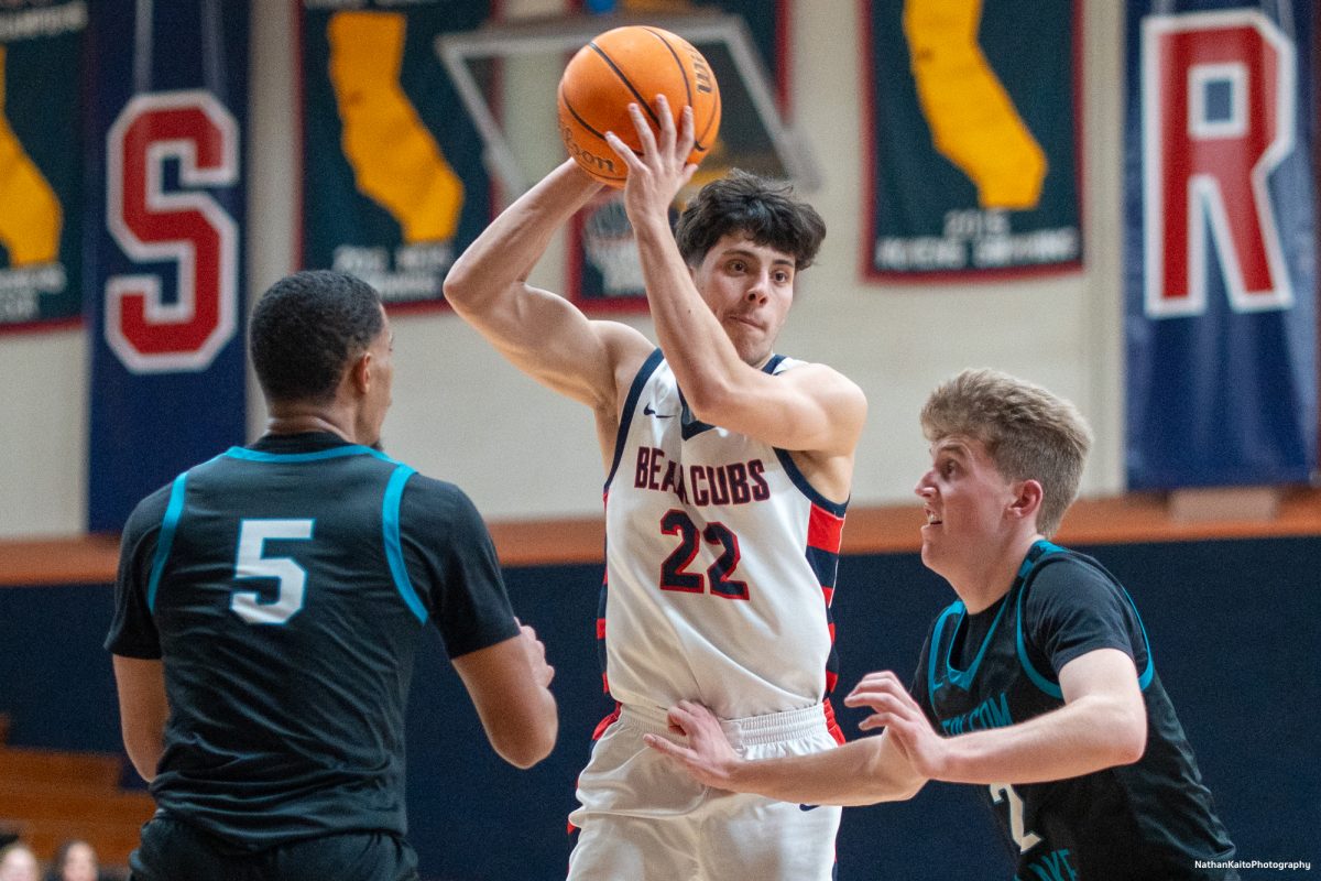 SRJC's guard Andrew Pengel shields the ball and assesses his options during the latter stages of the match against Folsom Lake at Haehl Pavilion on Friday, Feb. 14, 2025. 