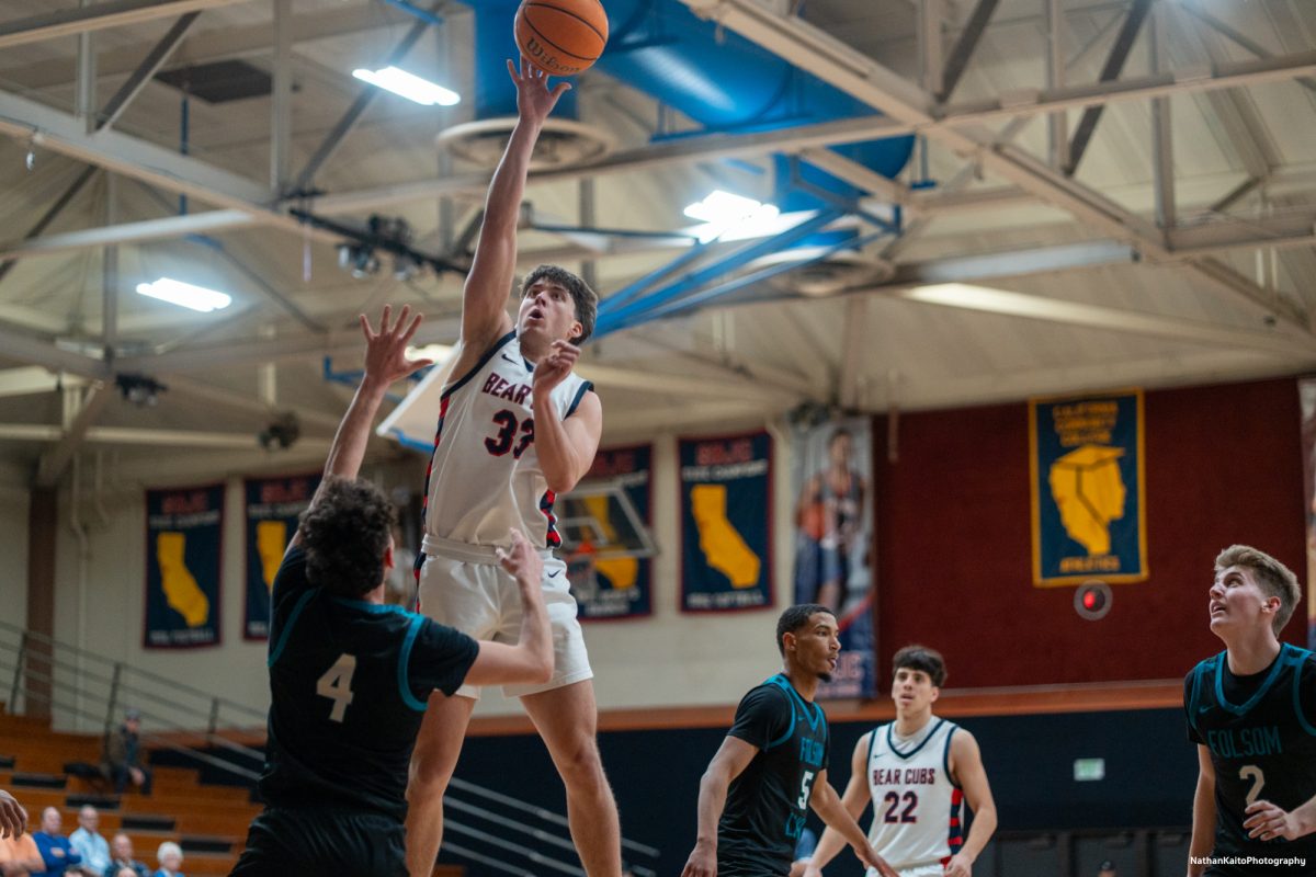 Bear Cubs' guard Audon Forgus leapos over Folsom Lake's Mikey Simonyan for a layup at Haehl Pavilion on Friday, Feb. 14, 2025. 