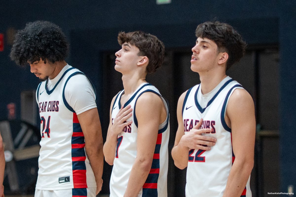 SRJC's Vincent Jackson left, Spencer Langowski, center, and right Andrew Pengel stand solemnly as the national anthem rings around Haehl Pavilion on Friday, Feb. 14, 2025. 