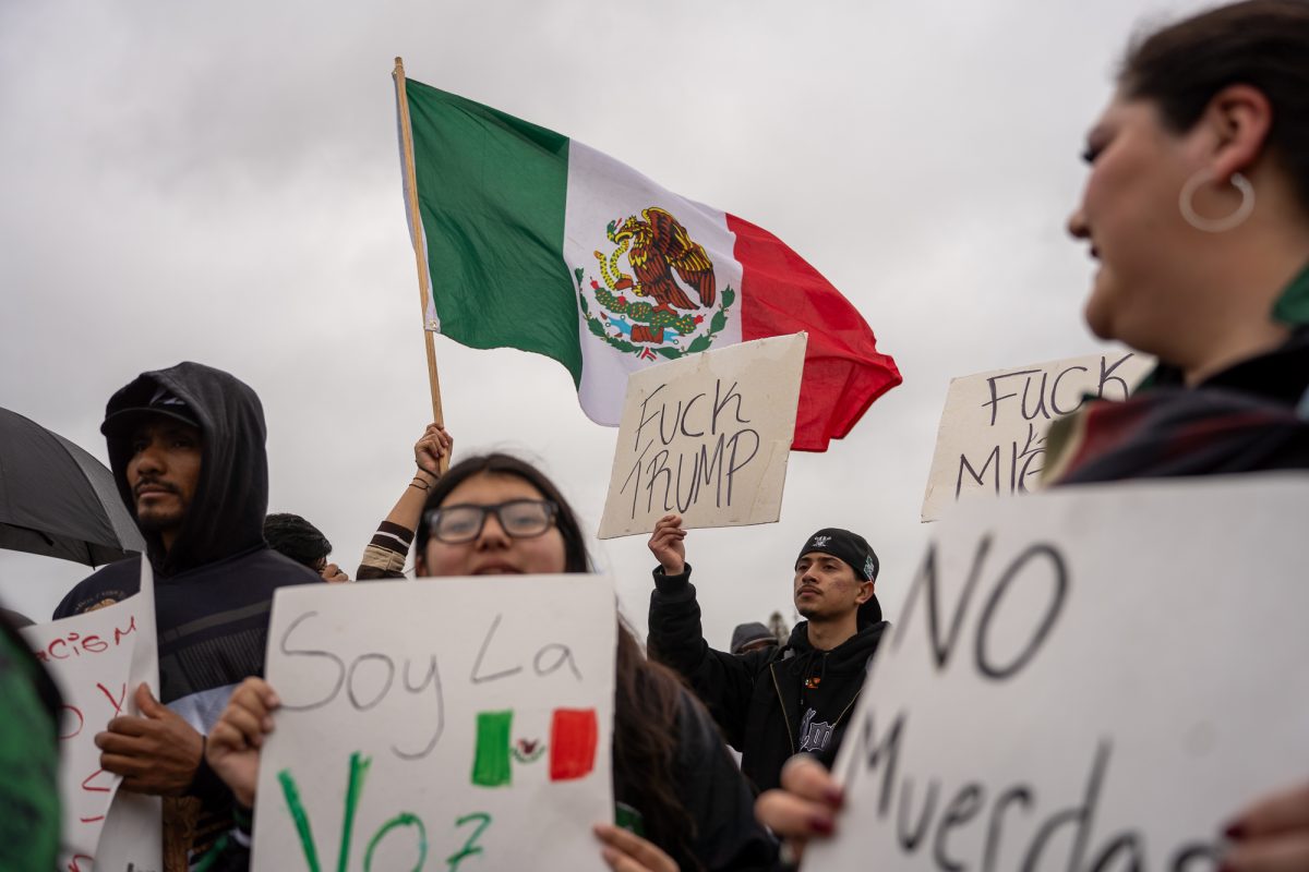 A crowd of protesters picket against the crackdown on immigration outside of Mitote Food Park on Monday, Feb. 3, 2025.