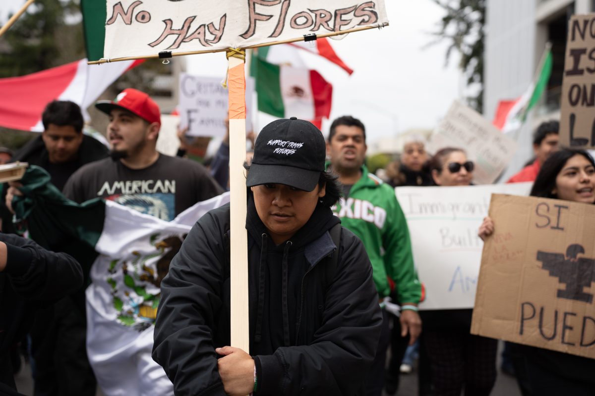 A protester leads the crowd to Mitote Food Park from Old Courthouse Square on Monday, Feb. 3, 2025.