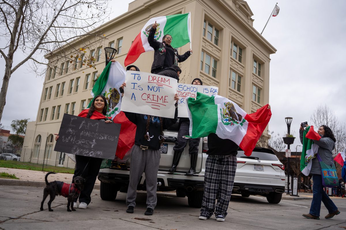 A group of picketers stand outside of Hotel E in protest of immigration crackdowns at Old Courthouse Square on Monday, Feb. 3, 2025.