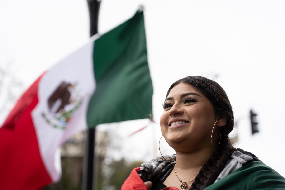 Crystal Favela Bautista stands in protest of immigration crackdowns at Old Courthouse Square on Monday, Feb. 3, 2025