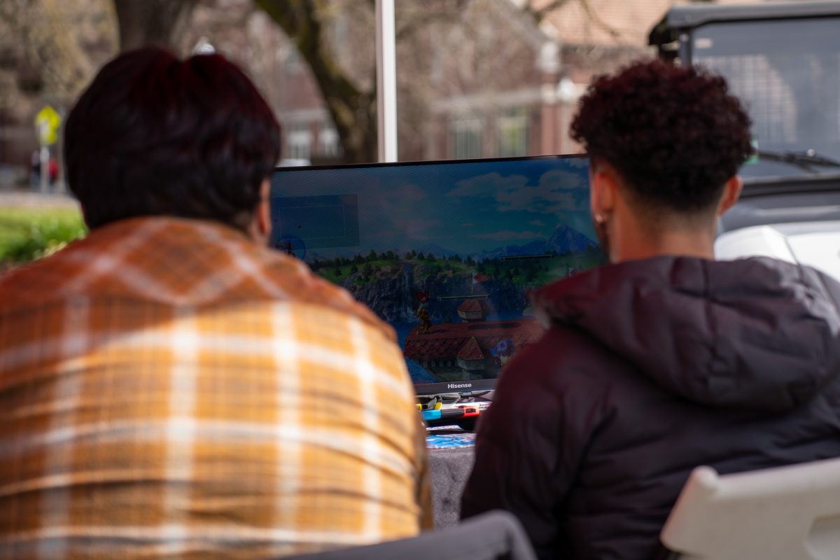 Two SRJC students play against each other in Super Smash Bros at the financial aid fun fair outside of Plover Hall on Wednesday, Feb. 12, 2025.