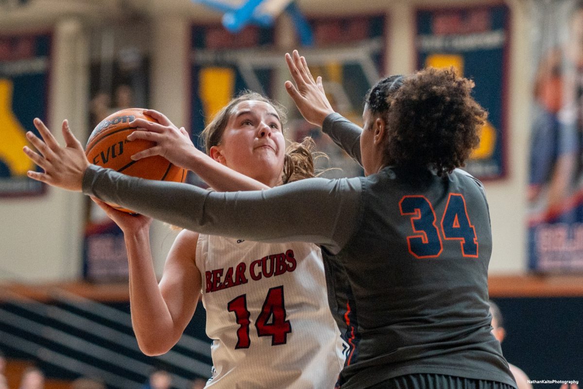 Bear Cubs forward Kaia Eubanks attempts to fight around Cosumnes River center Arianna Butler at Haehl Pavilion on Friday, Feb. 7, 2025.