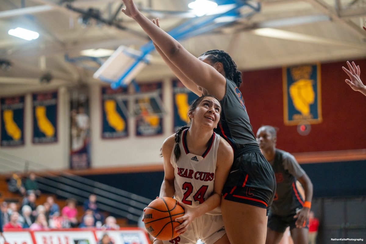 Bear Cubs' forward Cece Solano ducks under her defender and looks up to the hoop for layup against Cosumnes River on Friday, Feb. 7, 2025