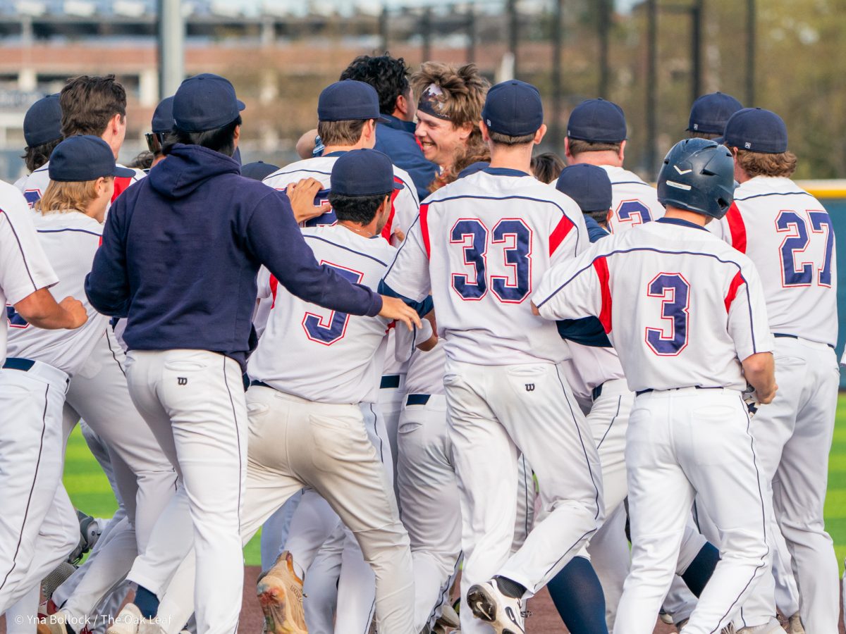 Sophomore catcher Mason Cox, center, celebrates with the team at first base after the walkoff win in the bottom of the eleventh against Sierra on Thursday, March 20, 2025 in Santa Rosa.