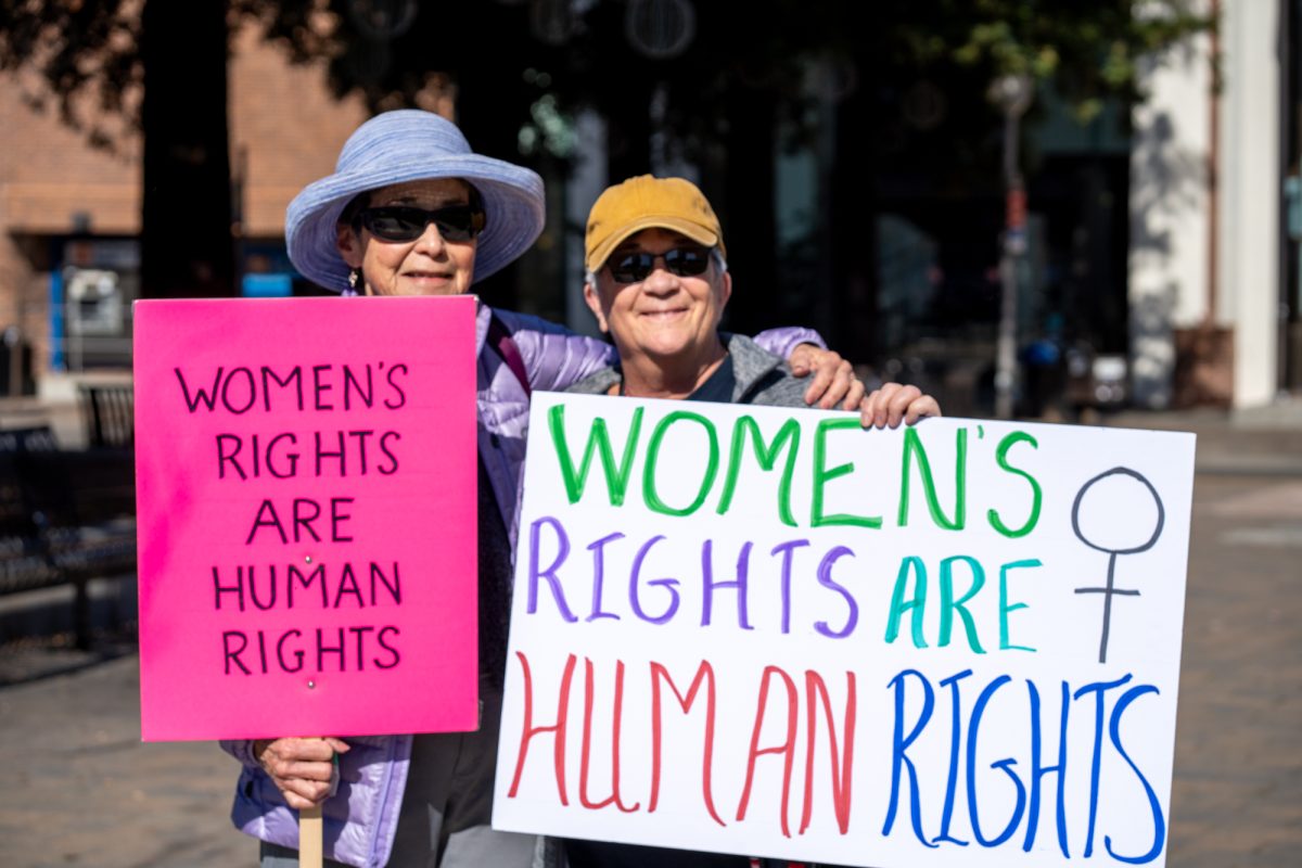 Demonstrators hold handmade signs during the International Women’s Day march in Old Courthouse Square on Saturday, March 8, 2025 in Santa Rosa.  