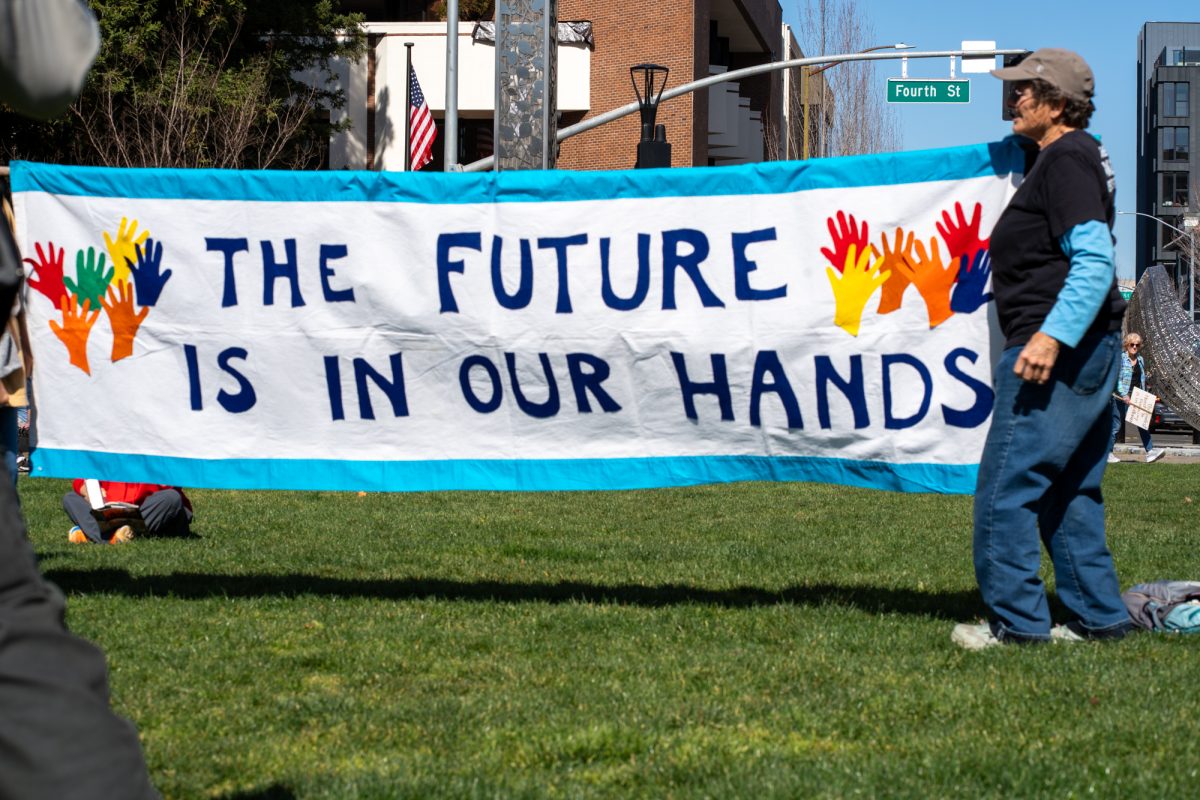 Demonstrators hold up a handmade banner that reads "The Future Is In Our Hands" during the International Women’s Day march in Old Courthouse Square on Saturday, March 8, 2025 in Santa Rosa.  