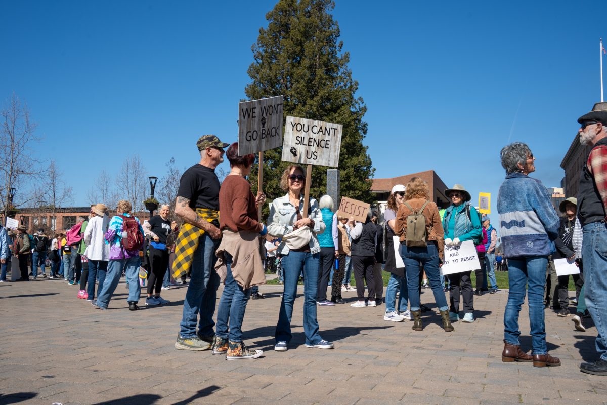 Demonstrators gather holding handmade signs during the International Women’s Day march in Old Courthouse Square on Saturday, March 8, 2025 in Santa Rosa.  