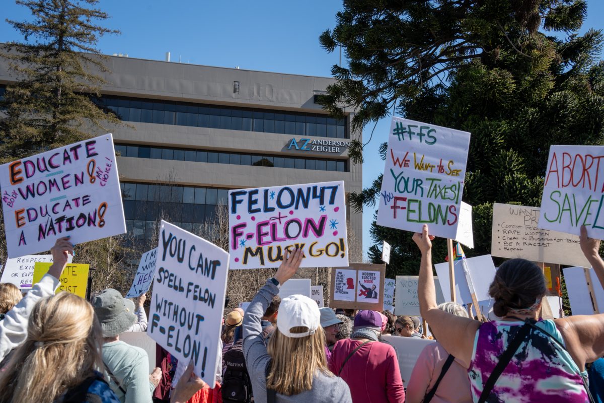 Demonstrators hold handmade signs during the International Women’s Day march in Old Courthouse Square on Saturday, March 8, 2025 in Santa Rosa.  