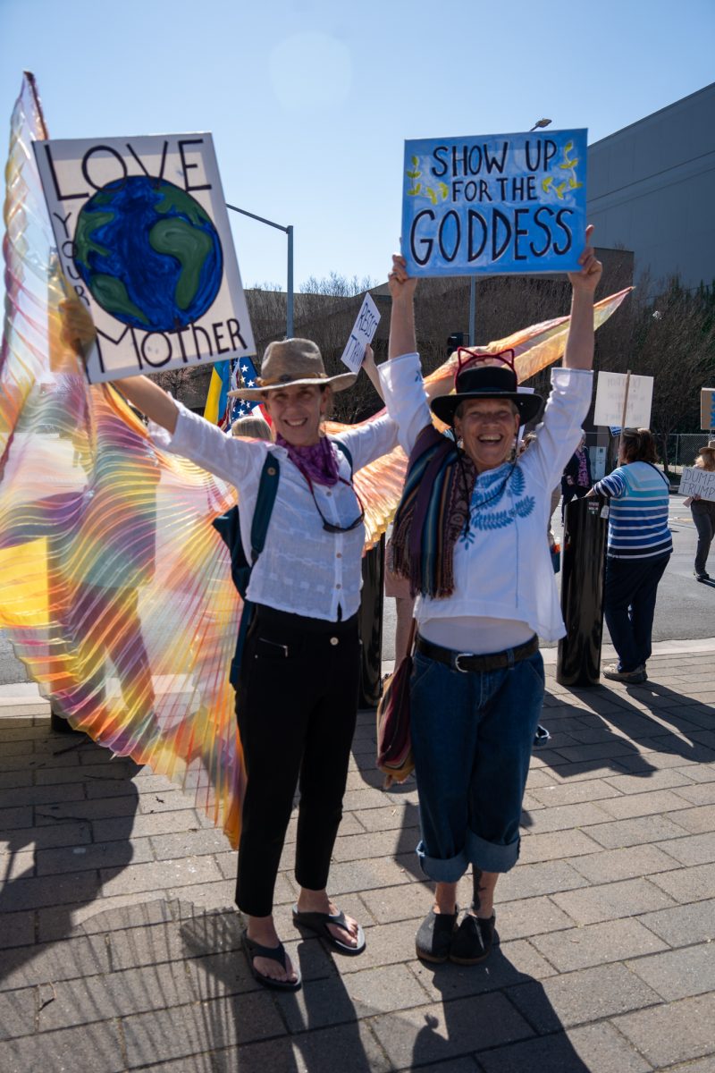 Demonstrators hold signs in support of the International Women’s Day march in Old Courthouse Square on Saturday, March 8, 2025 in Santa Rosa.  