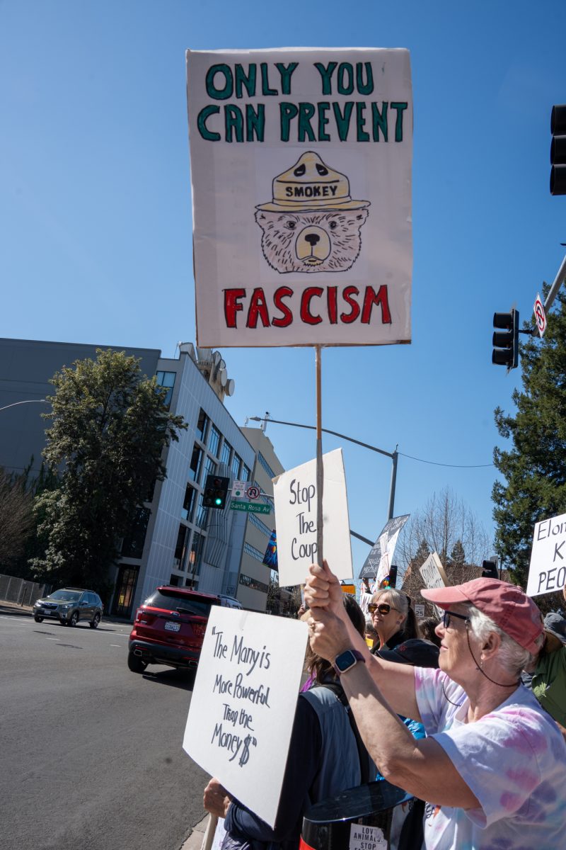 A hand drawn sign is held up by a demonstrator in support of the International Women’s Day march in Old Courthouse Square on Saturday, March 8, 2025 in Santa Rosa.  