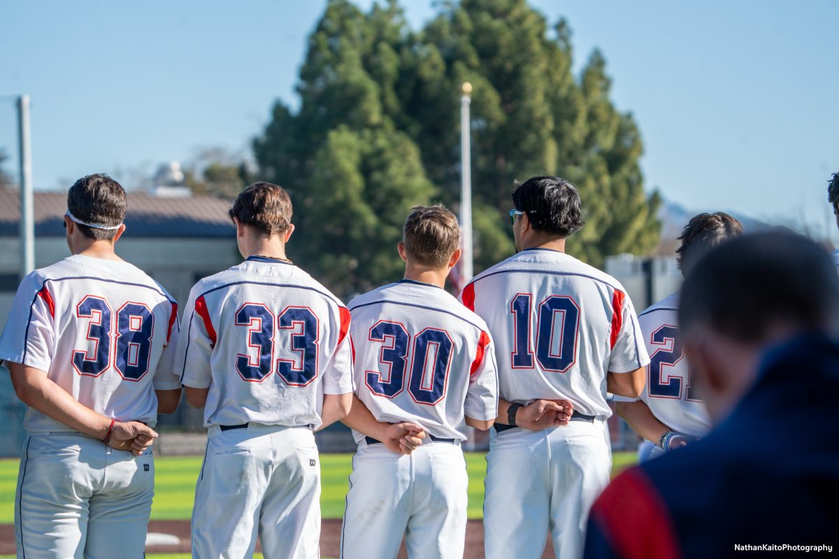 The SRJC Bear Cubs stand for the national anthem at Cook Sypher Baseball Field 