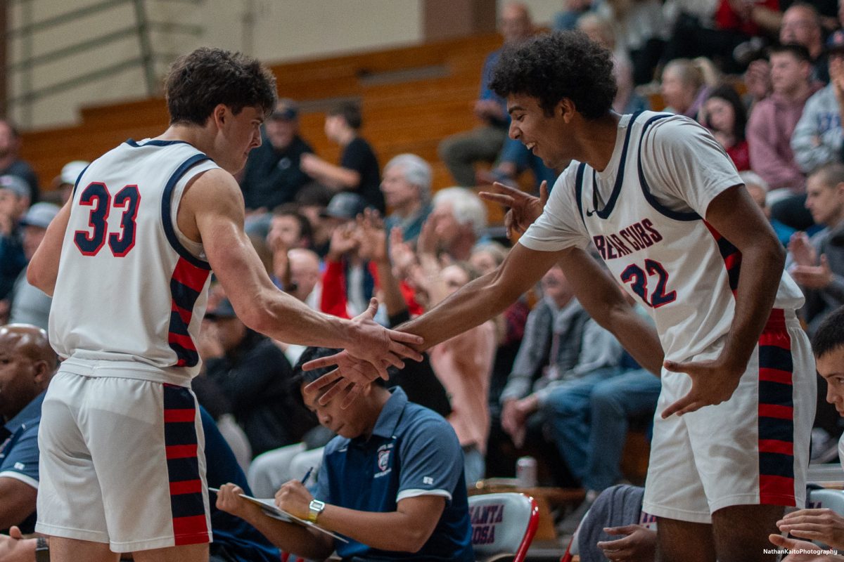 SRJC forwards Audon Forgus and Jaden Washington high-fives each other on the bench, celebrating a bucket against Yuba on Saturday, Mar. 1, 2025 at Haehl Pavilion.  