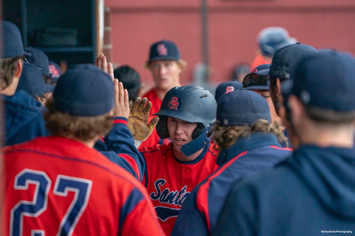 Santa Rosa Junior College's right fielder Ayden Herrguth high fives his teammates as he returns to the dugout after he makes back to home-plate, responding to a strong fourth inning from San Joaquin Delta on Saturday, March 15, 2025 in Santa Rosa.