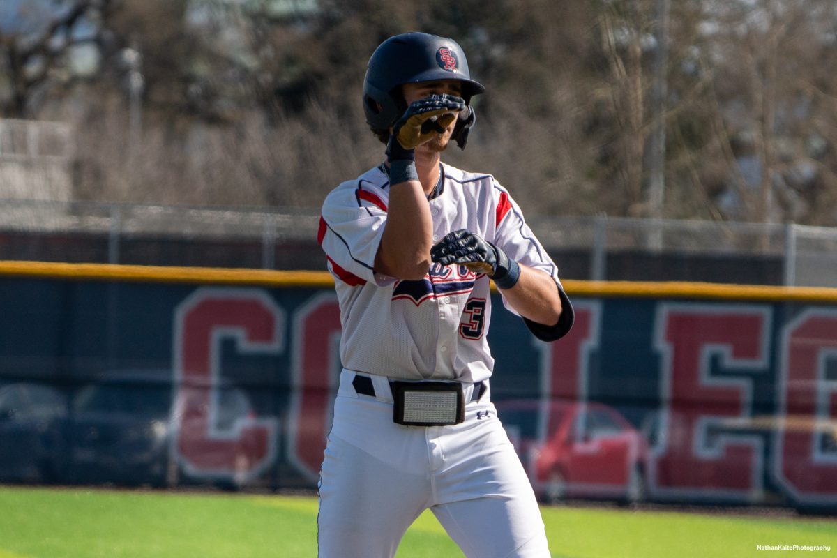 Santa Rosa Junior College's infielder Caze Derammelaere signals to the dugout with a snake after making it to first base against San Joaquin Delta on Tuesday, March 11, 2025 in Santa Rosa.