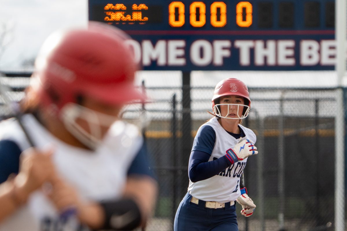 SRJC shortstop Kylee Bauman prepares to run from third base as batter, Gabby Schenone gets ready to bat against Folsom Lake at Marv Mayes Softball Field on Tuesday, Mar. 4, 2025. 