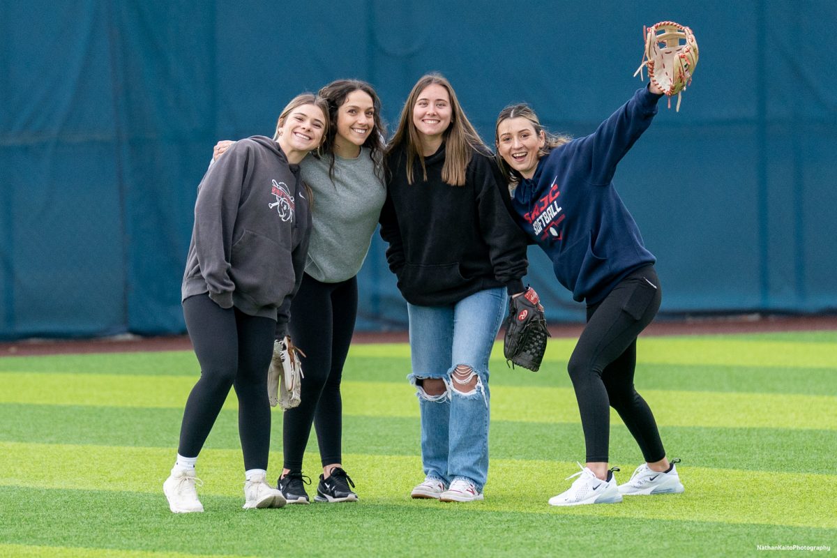 From left to right, alumni Carmen Haugen, Cayla Nixon, Emma Falberg and Kayla Vance smile from the outfield during the alumni Home Run Derby on Saturday, March 15, 2025 in Santa Rosa.